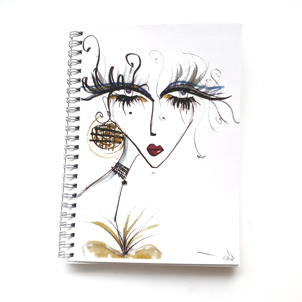 Ruled Notebook with cover of lady with long magical lashes by Talia Zoref