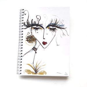 Ruled Notebook with cover of lady with long magical lashes by Talia Zoref